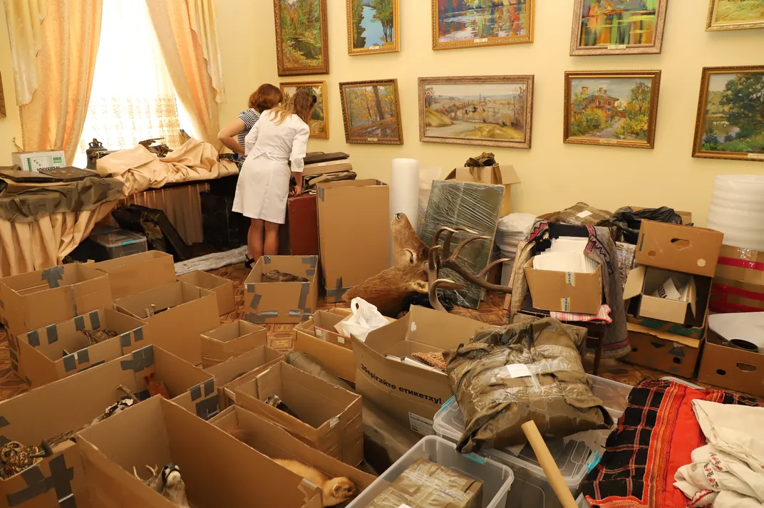 Conservators work with hastily packed collections