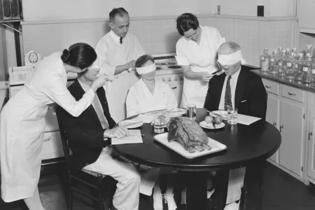 Bureau of Home Economics employees blindfold their taste testers so the sight of the turkey doesn't bias any responses, 1930s.