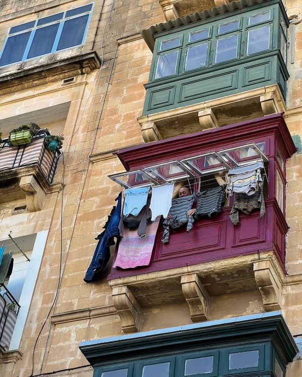 A man hanging laundry on the 3rd floor thumbnail