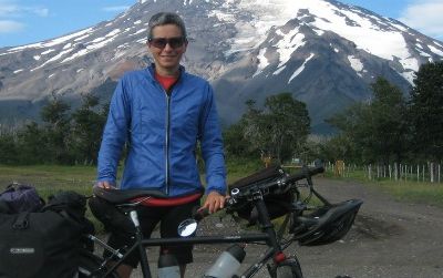 Pauline Symaniak, shown here before Volcan Lanin in Argentina, has been pedaling around the earth for 18 months. Much of New Zealand has failed to amaze her.