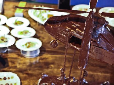 U.S. Army Pvt. Nicholas Marker of Fort Campbell, Ky., constructs a chocolate helicopter, that sits on display at the 36th Culinary Arts competition on Fort Lee, Va., March 5, 2011. The chocolate center piece is displayed as part of the cold foods table category in which Marker received a bronze medal. (U.S. Army photo by Spc. Courtney Lindsay/Released)