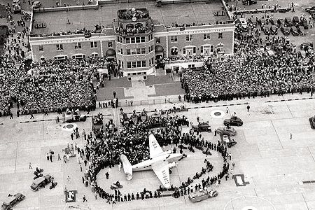 On July 14, 1938, thousands gathered for the return of Howard Hughes, who in four days had flown a Lockheed Super Electra around the world.