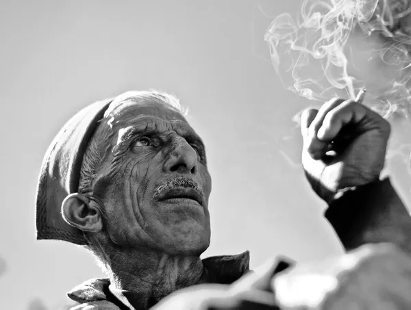 An old Himachali man smoking at a local festival thumbnail