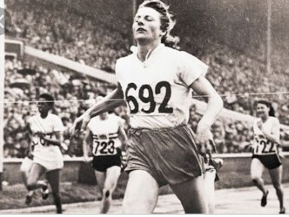 Fanny Blanker-Koen crosses the finish line to become the first triple champion of the 14th Olympic Games.