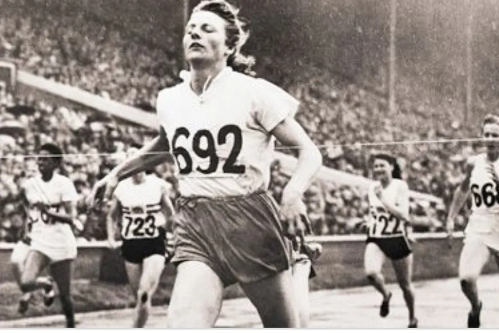 Fanny Blanker-Koen crosses the finish line to become the first triple champion of the 14th Olympic Games.