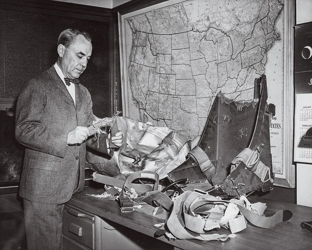 man with bowtie holding seatbelts