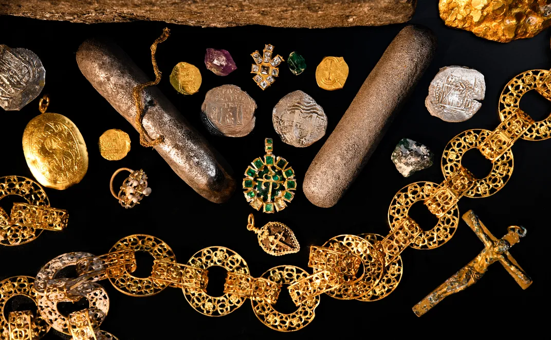 Coins and high-status personal belongings, including gold jewelry, chain and pendants, recovered from the wreck of the Maravillas