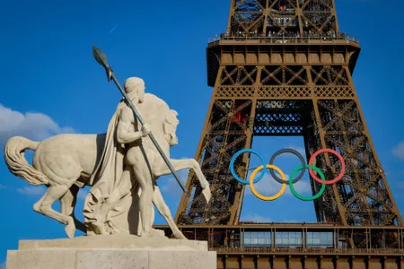 Olympic rings are seen on the Eiffel Tower near the restored statue of "Cavalier Arabe" on the Pont d'I&eacute;na bridge in Paris on July 4, 2024, ahead of the upcoming Paris 2024 Olympic Games.&nbsp;