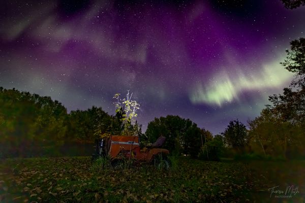 Old lawn mower and Northern Lights thumbnail