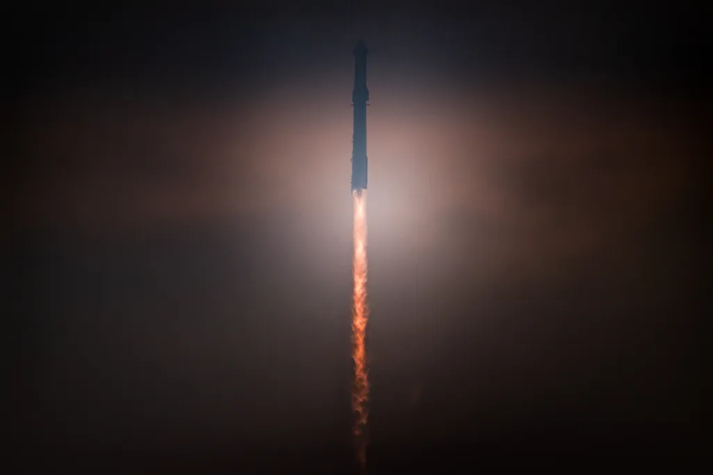 A rocket launches into a dark sky