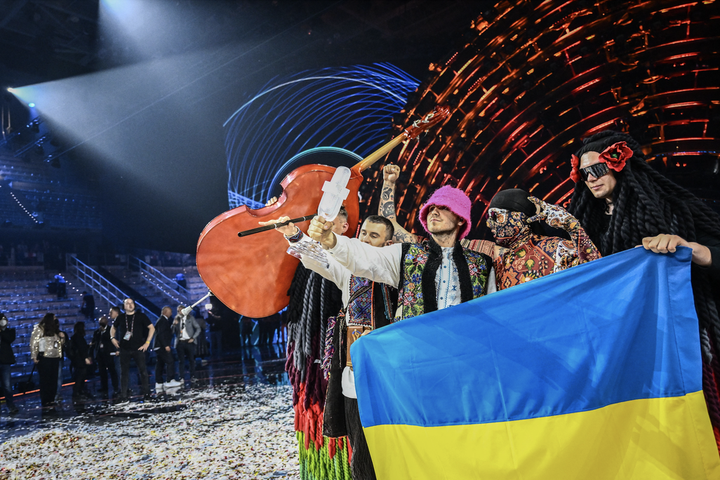 Members of the band Kalush Orchestra pose onstage with the winner's trophy and Ukraine's flags after the Eurovision Song Contest on May 14, 2022.