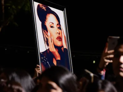 Fans hold a photo of Selena during the ceremony honoring her with a star on the Hollywood Walk of Fame in 2017.