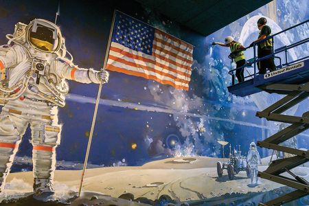 The Museum’s murals were taken down in sections; here, a contractor identifies the canvas seams on Robert McCall’s A Cosmic View.