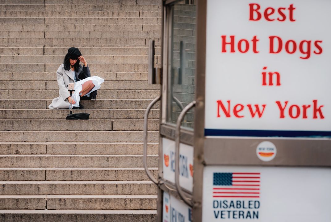 a women sits on a marble staircase