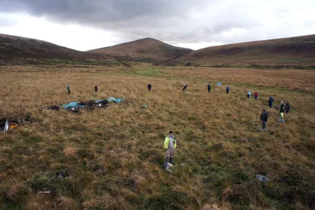 The team stands around one of the stone circles.