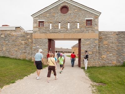 Visitors enter Historic Fort Snelling. A new exhibition at the site examines the fort&#39;s long, complex history.