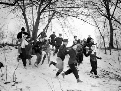 "Young people run down a snowy hill with enthusiasm, ca. 1940" in Chicago