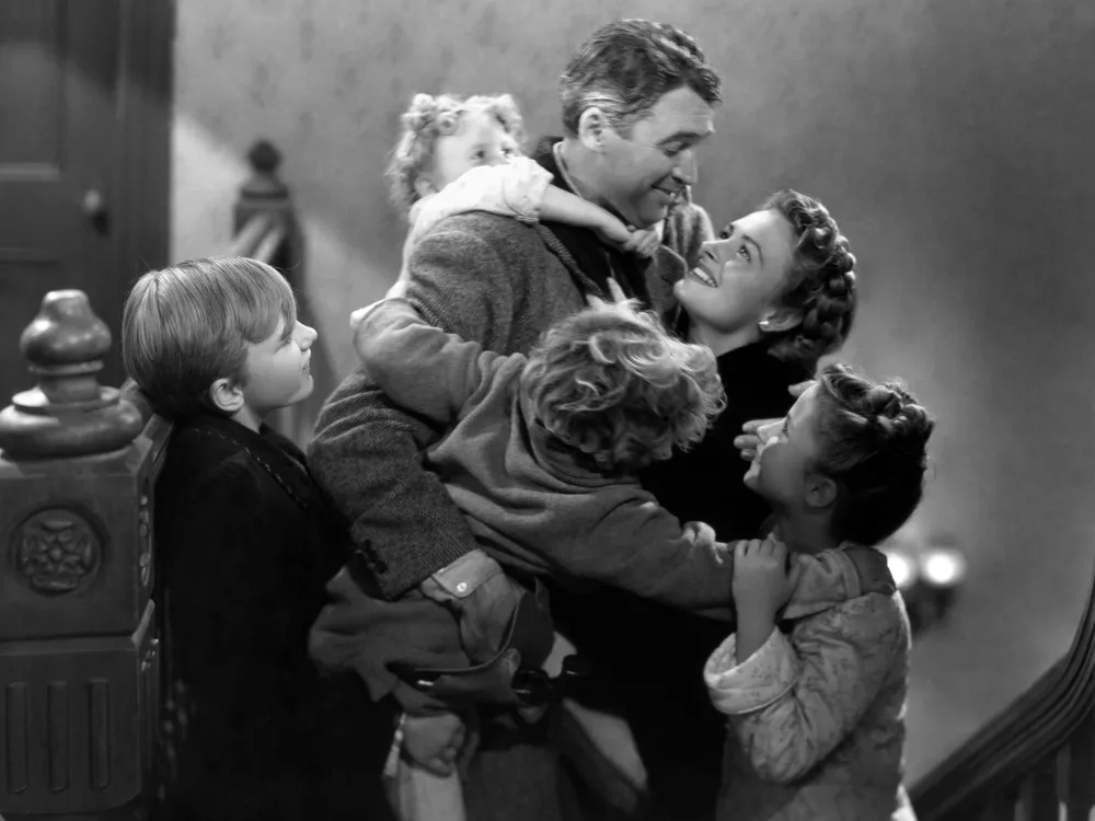 George and Mary Bailey, played by James Stewart and Donna Reed, hug their children in a still from "It's a Wonderful Life"
