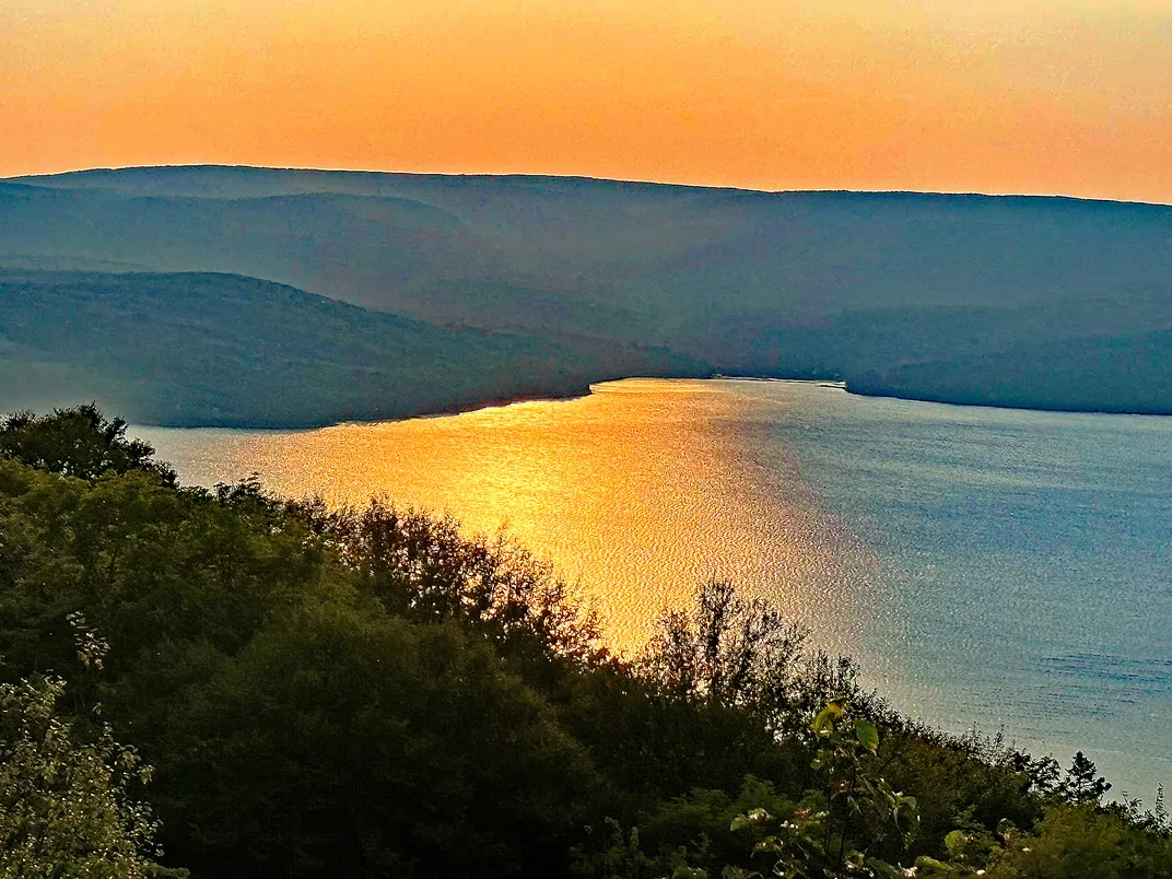 9 - Bras d’Or Lake reflects the golden glow of the sunset over Cape Breton Island on a clear summer evening.