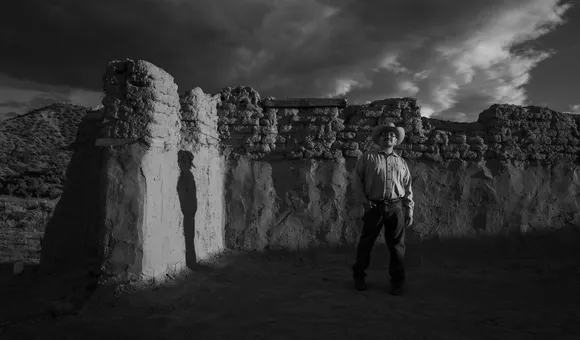 Genízaro Delvin Garcia standing in remains of the 18th-century Santa Rosa de Lima Church. Abiquiú, New Mexico, 2019. (© 2020 Russel Albert Daniels) 
