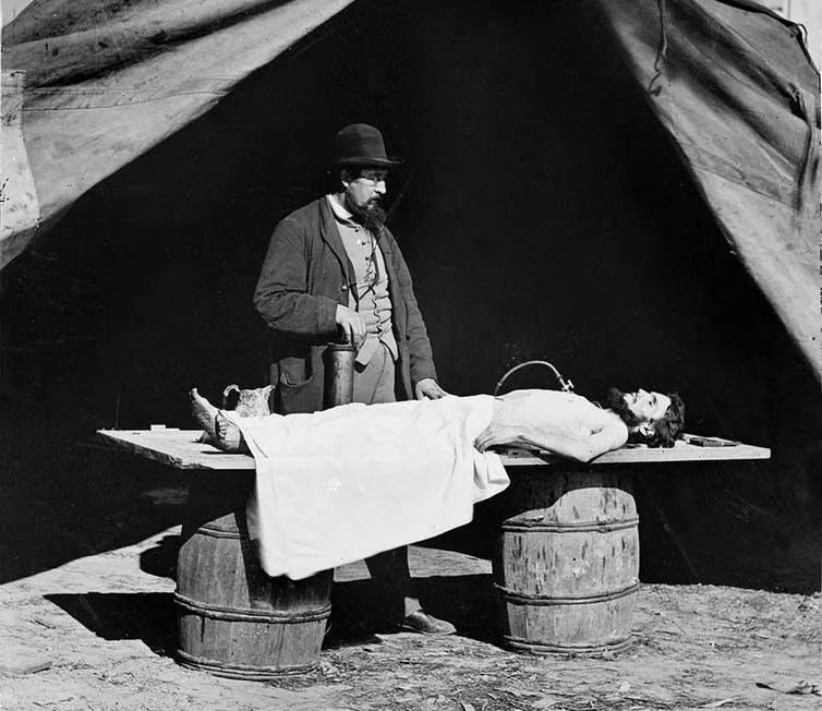 A surgeon embalms a soldier’s body during the Civil War