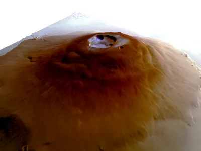 A simulated perspective of Olympus Mons, the tallest volcano in the solar system, with water frost at its peak.
