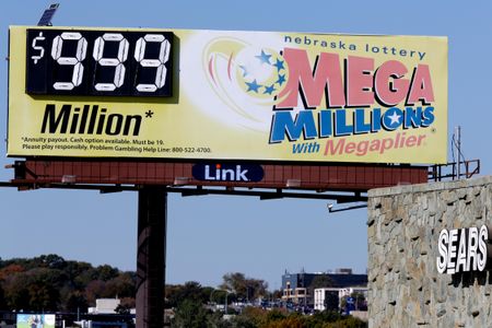 A Mega Millions billboard in Omaha, Nebraska, adjacent to a Sears store, shows $999 million, the maximum number it can show, 