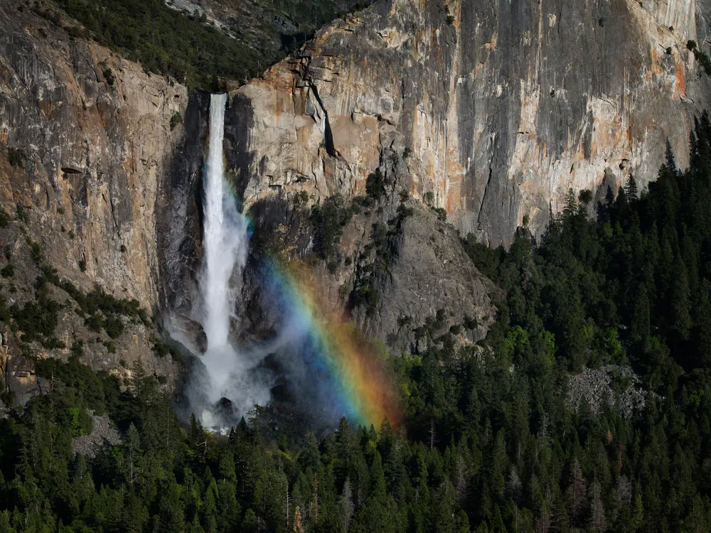 The spray from the cascade of Bridalveil Falls captures sunlight