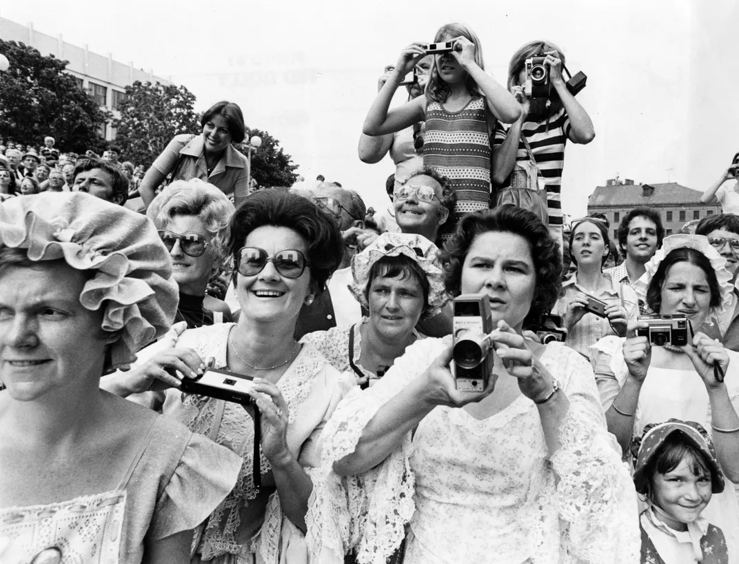 Spectators at City Hall Plaza in Boston try to capture Elizabeth II on film on July 11, 1976.