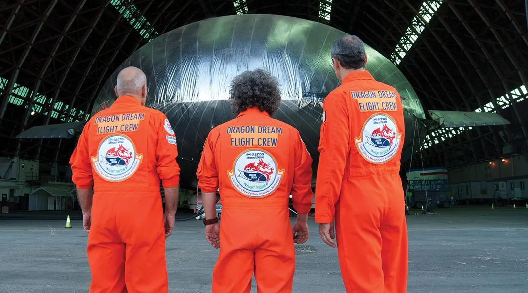 three people wearing orange jumpers