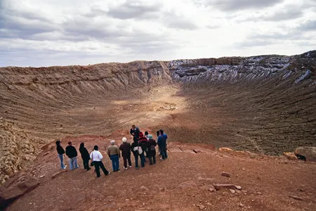 Visitors take a guided tour of the Barringer Meteorite Crater in northern Arizona.