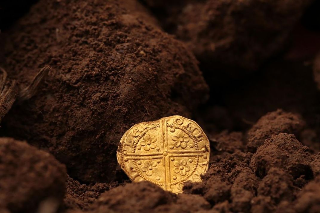 Opposite side of gold coin featuring cross symbol