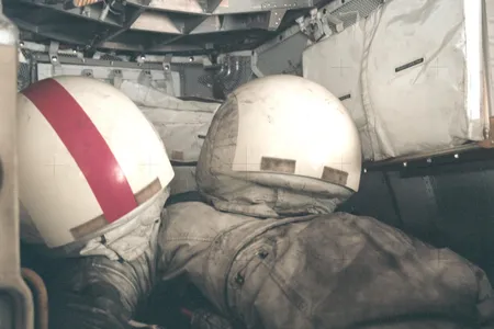 Two Apollo EVA spacesuits, covered in dark gray lunar dust. The short times spent on the Moon by the Apollo astronauts meant that the long-term issues associated with dust could be ignored during those missions.