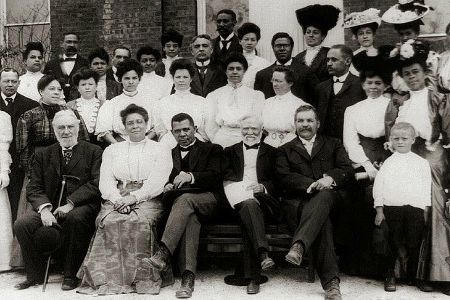 Industrialist Andrew Carnegie (front row, center) financially supported the Tuskegee Institute and its faculty members, pictured here. Carnegie lauded the efforts of Booker T. Washington, who opened the school in 1881, shown here with his wife Margaret next to the businessman.