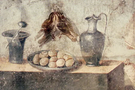 A painting found in Pompeii depicting eggs, bronze dishes and two small birds hung on a wall
