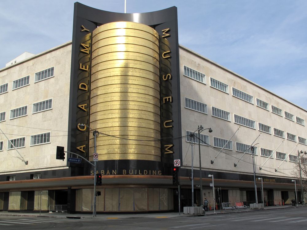 Large beige building with golden sign that reads Academy Museum