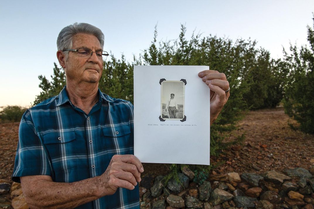 William Kessel holds up a portrait of Edwards with a snake around his neck.