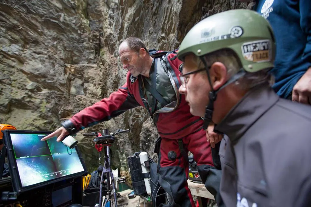 Polish explorers check a footage from a remote-operated vehicle deep in the Czech Republic's deepest cave.