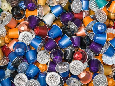 A huge pile of used disposable Nestle Nespresso coffee capsules in various colors on a garbage heap in Switzerland. The popular capsules are collected after use in order to recycle the aluminum parts.