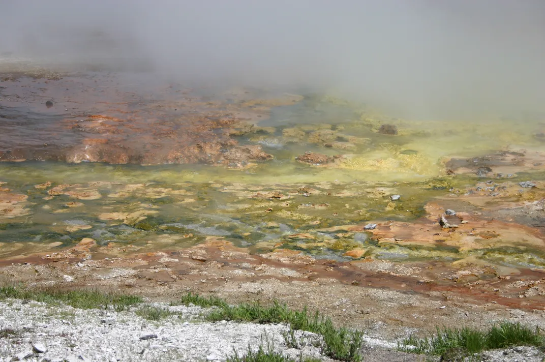 hot water and rocks, some of the water stained green