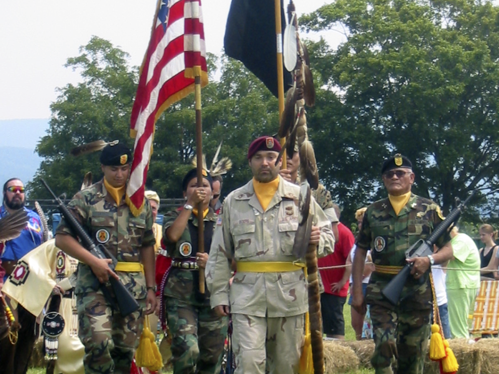 On mid-tour leave from Operation Iraqi Freedom, Sergeant First Class Chuck Boers carries in the eagle staff at the Shenandoah Powwow, 2004. (Courtesy of Chuck Boers)