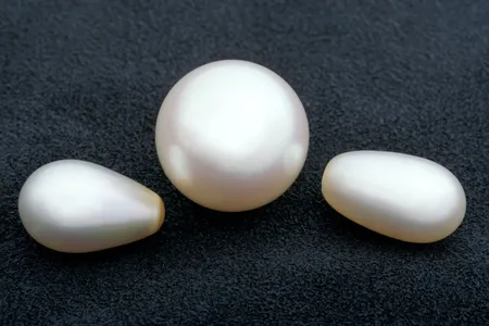 Smooth pearls in the shape of orbs and ovals are usually created by bivalves, like mussels, in pearl farms. As with all gems, the less blemishes they have, the more valuable they are. (Chip Clark, Smithsonian)