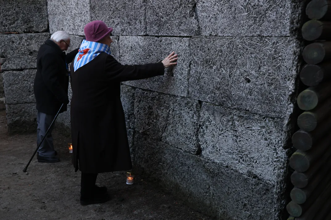 Two people touching their hands to a wall