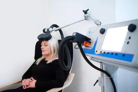 In transcranial magnetic stimulation, a magnetic device placed near the skull delivers painless pulses to the brain.