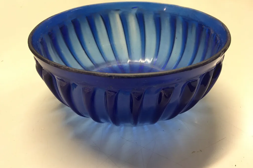 A close up shot of the blue glass bowl on a table