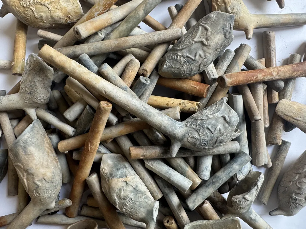 A pile of decorated tobacco pipes