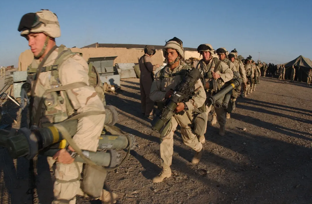 American Marines walk to their helicopters as they deploy to Afghanistan in 2002.