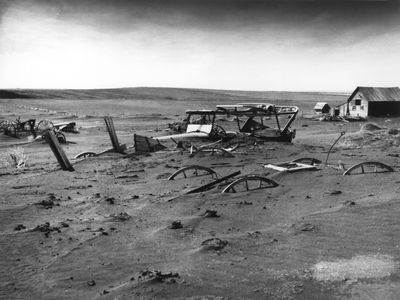 Buried farm machinery in Dallas, South Dakota during the Dust Bowl in 1936.