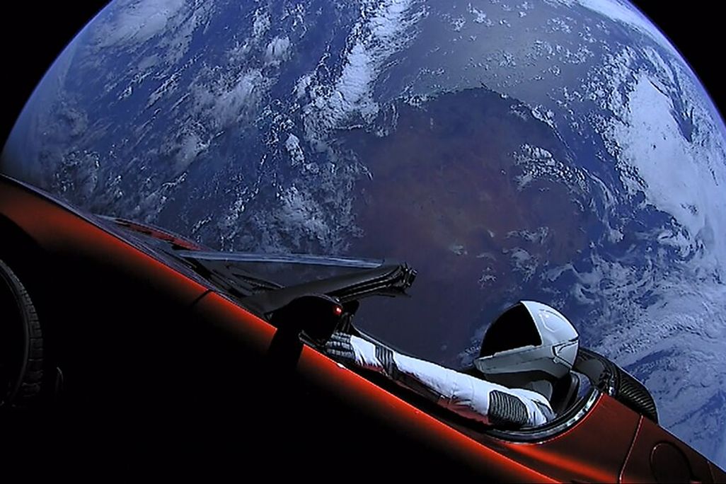 Elon Musk's Tesla Roadster on the Falcon rocket, with Earth in background