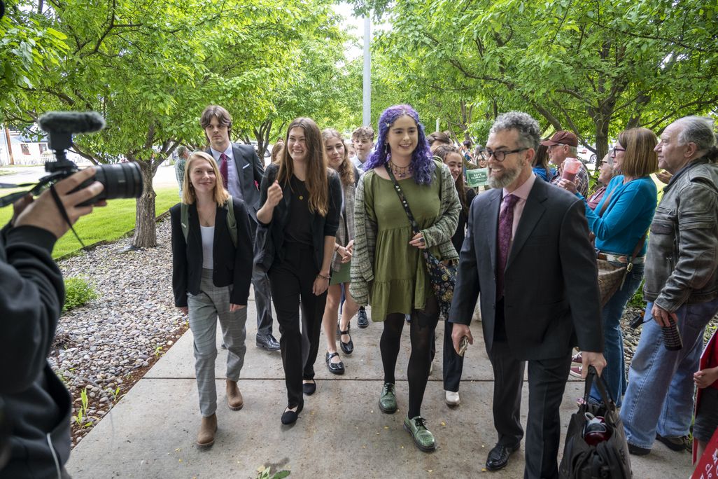 Group of people walking down a sidewalk